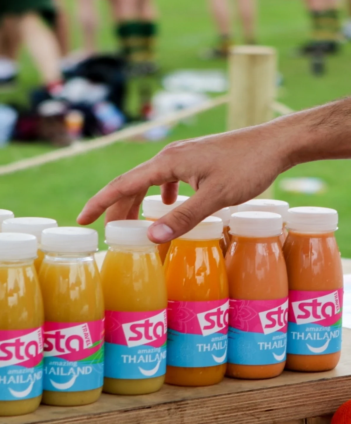 A collection of branded juice bottles with the STA logo on them